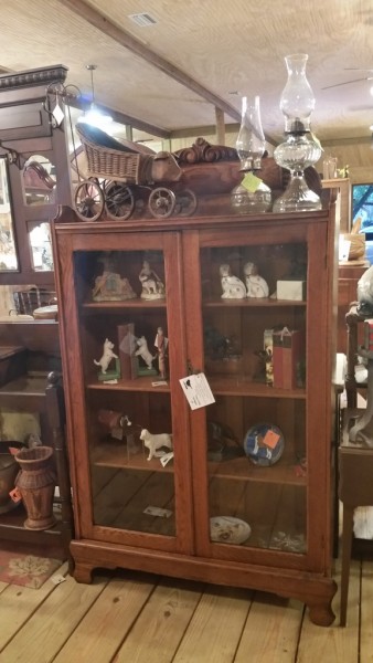 Beautiful antique solid chestnut China display cabinet with incredible hand carved crown and aged patina. $850.00