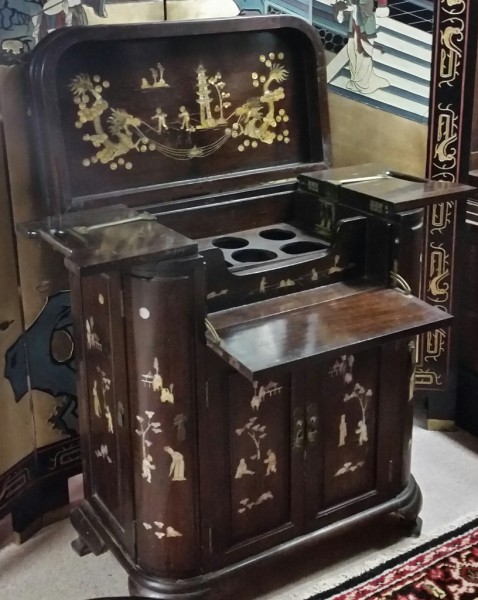 Mid 20th century Asian inlaid bar with retractable bottle section, two doors center, two end drawers, and two cupboard ends. Teak with beautiful mother of pearl inlay.